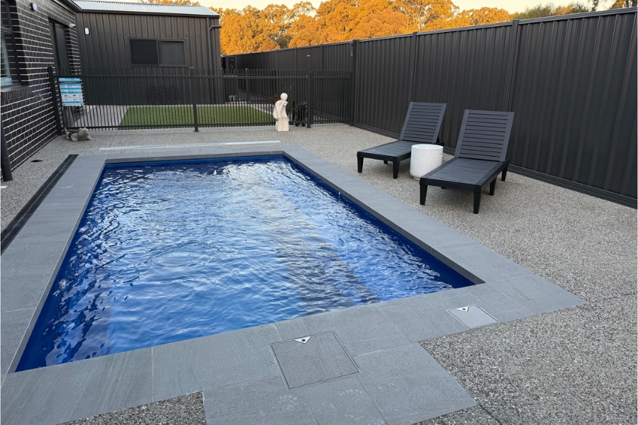 Concrete pool surround with bluestone coping and the alfresco beyond, Maiden Gully.
