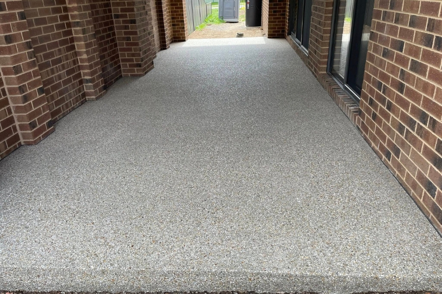 Covered exposed aggregate walkway beside a brick home, Bendigo.
