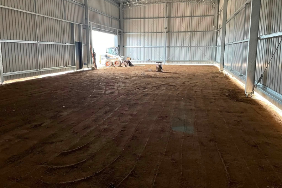Compacted dirt floor being prepared inside a steel shed ahead of a concrete pour, Epsom.