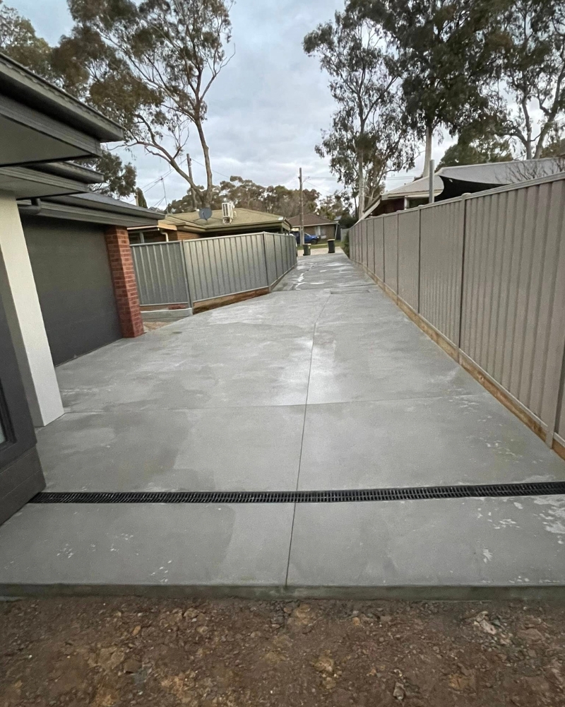Long residential driveway with a strip drain set across the width to capture stormwater, Lockwood.
