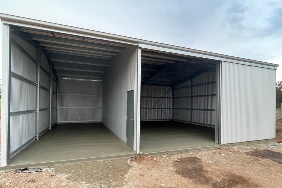 Two-bay shed slab poured to the engineering sheet — more posts means more footings and more prep, Central Victoria.
