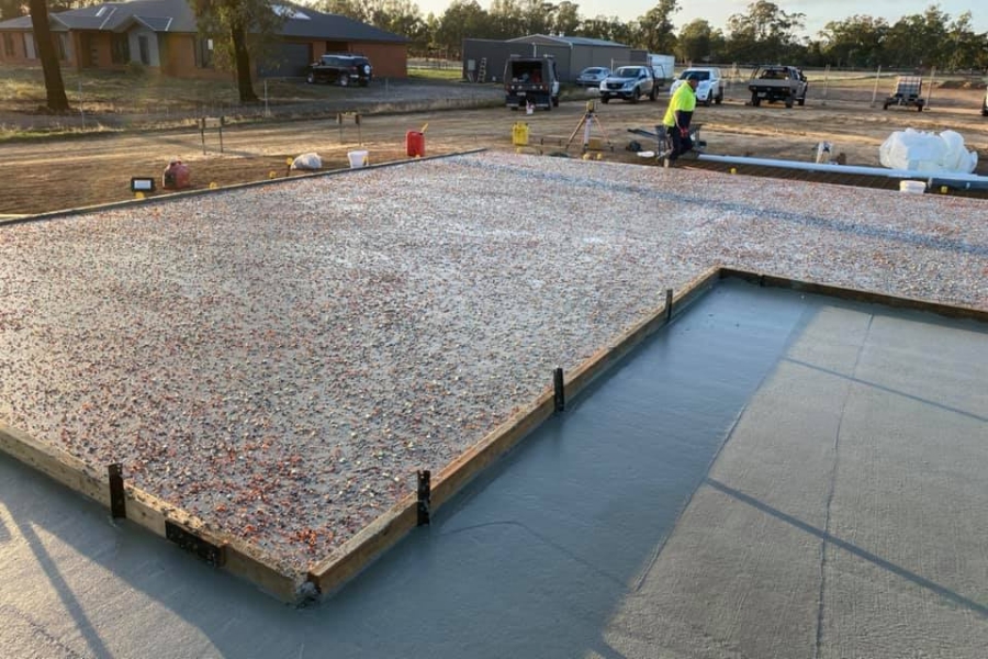 Fresh exposed aggregate slab before wash-back beside a plain concrete section, Huntly build.