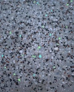 Schnepp recycled-glass exposed aggregate blend by daylight, mint-green glow fragments visible, Huntly.