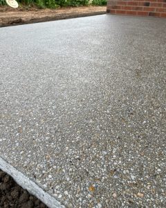 Close-up angled view of a salt-and-pepper exposed aggregate finish, Junortoun.