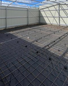 Shed slab infill prep inside an erected kit shed — moisture barrier, mesh and tie-downs to spec, around Bendigo.