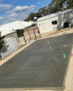 Cured shed slab with plumbing penetrations for a workshop wet area, Bendigo region.