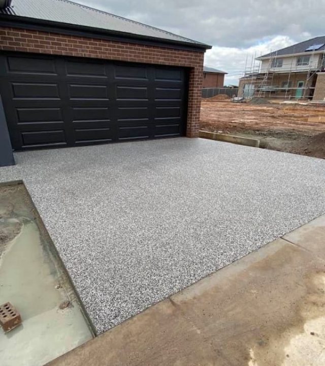 Light-toned exposed aggregate driveway freshly laid at a new home build, Kangaroo Flat.