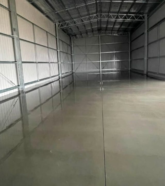 Smooth finished concrete shed slab ready for use inside a steel-frame shed, Strathfieldsaye.